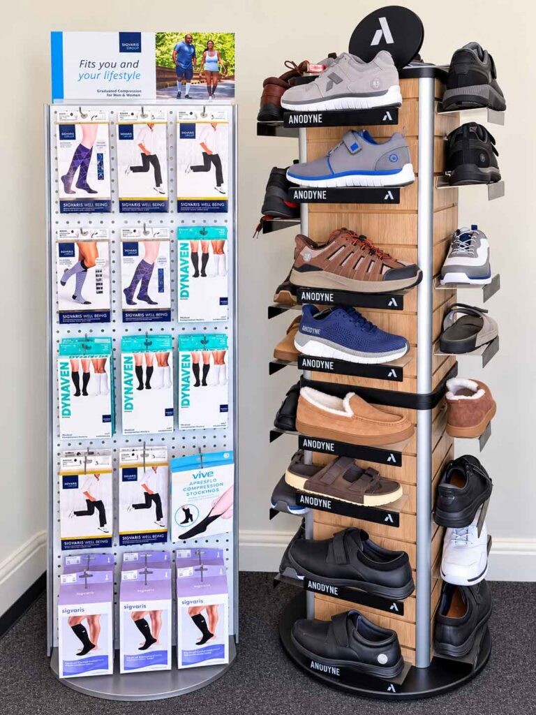 ACI Medical Supplies display rack of medical compression products and footwear.