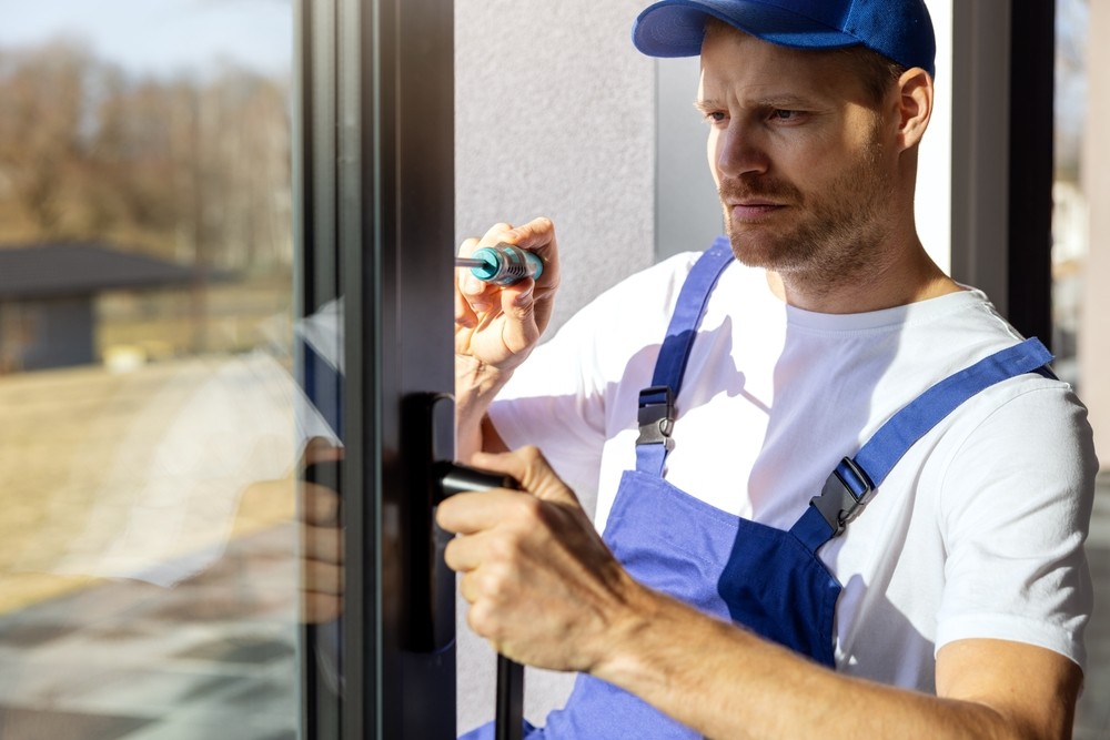 Callender's House of Glass technician installing a glass window door handle