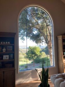 Callender's House Of Glass arched window with decorative black grid inside a home