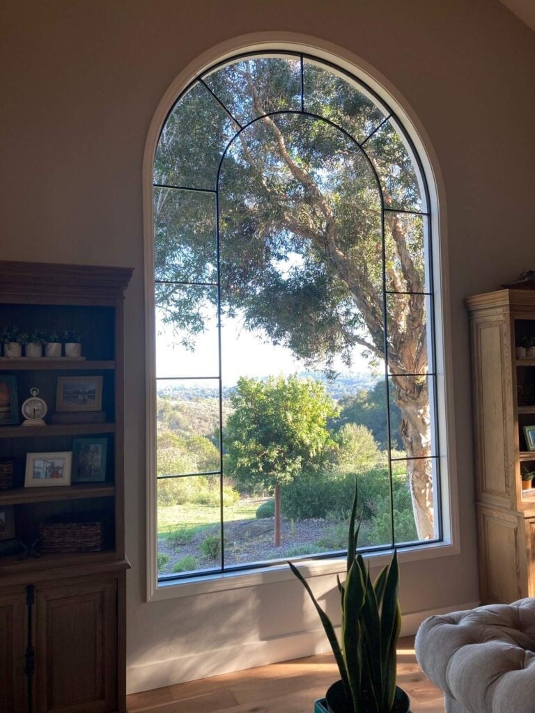 Callender's House Of Glass arched window with decorative black grid inside a home