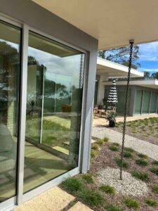 Callender's House Of Glass glass doors and windows at a modern outdoor patio