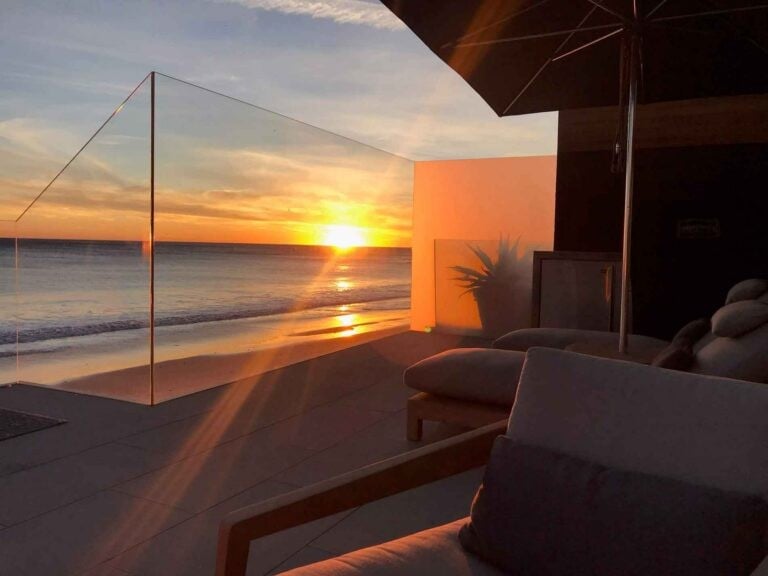 Callender's House of Glass patio glass panels at sunset overlooking the ocean