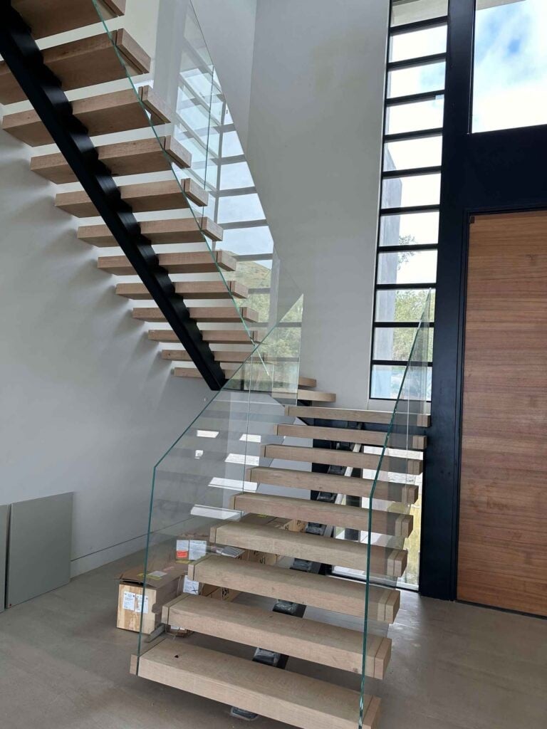 Callender's House Of Glass installation of frameless glass staircase with wooden treads