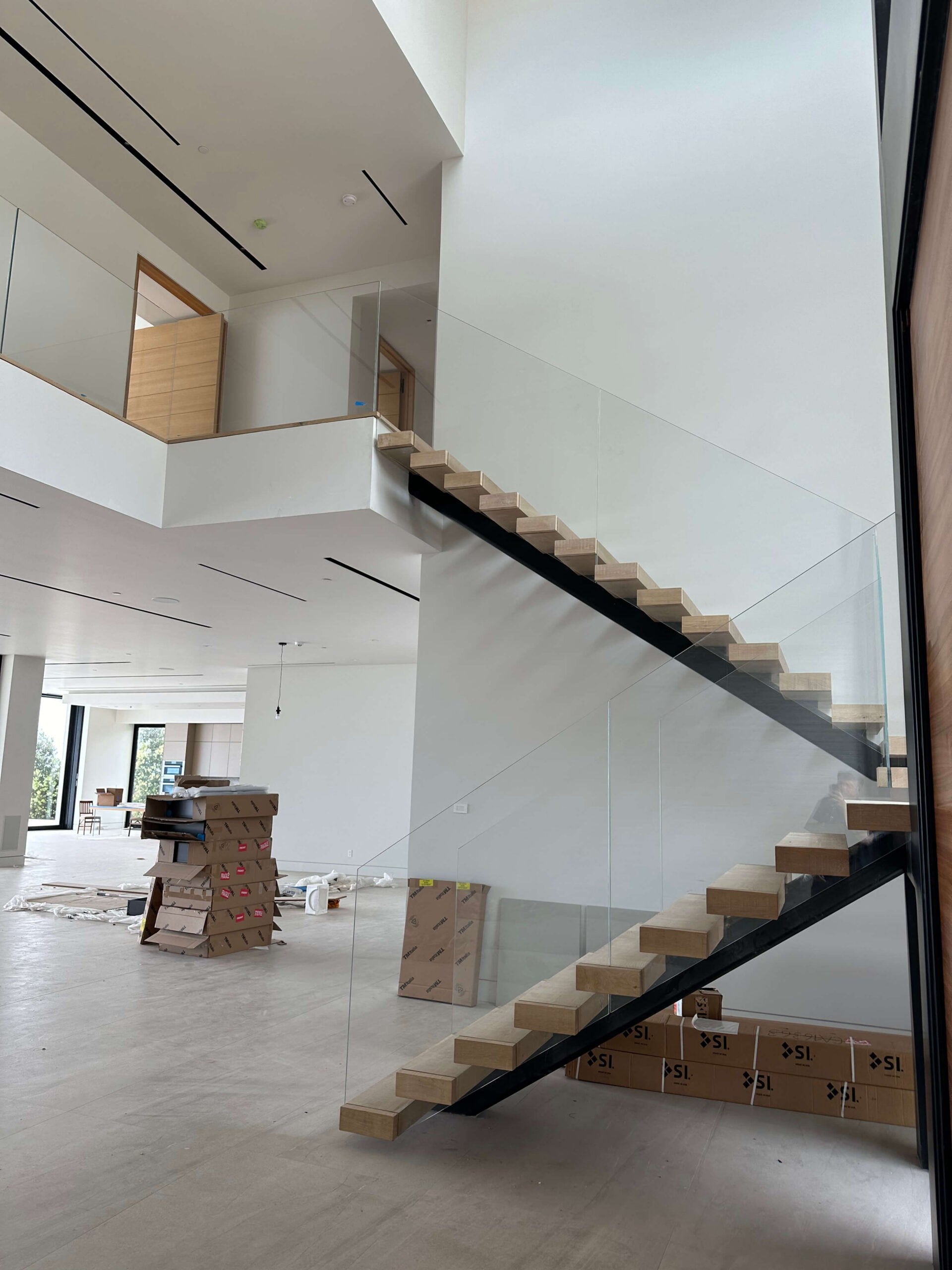 Callender's House Of Glass interior glass staircase with railing during installation