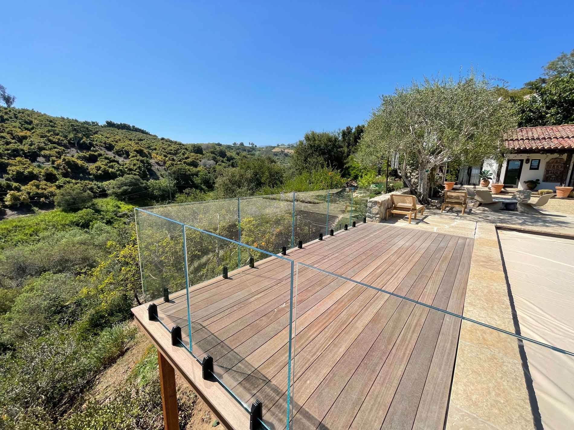 Callender's House Of Glass outdoor glass railing and patio with mountain view