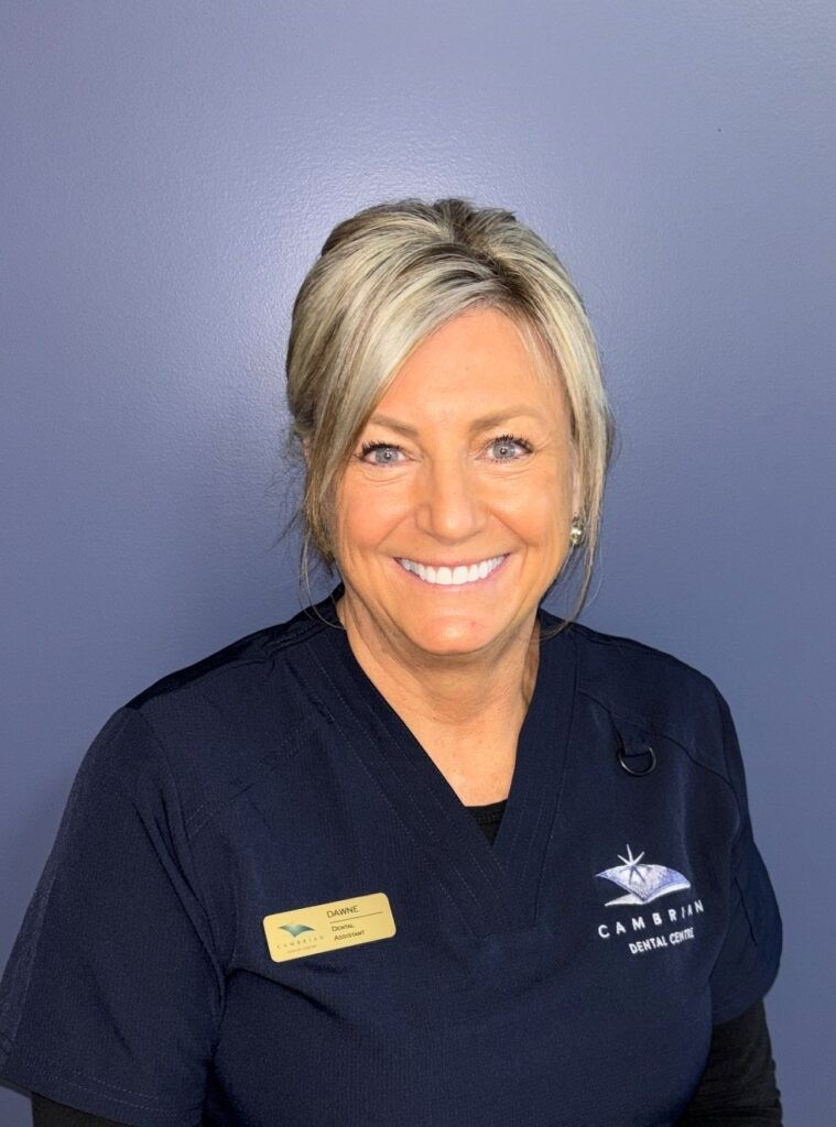 Smiling dental assistant in Cambrian Dental Centre scrubs