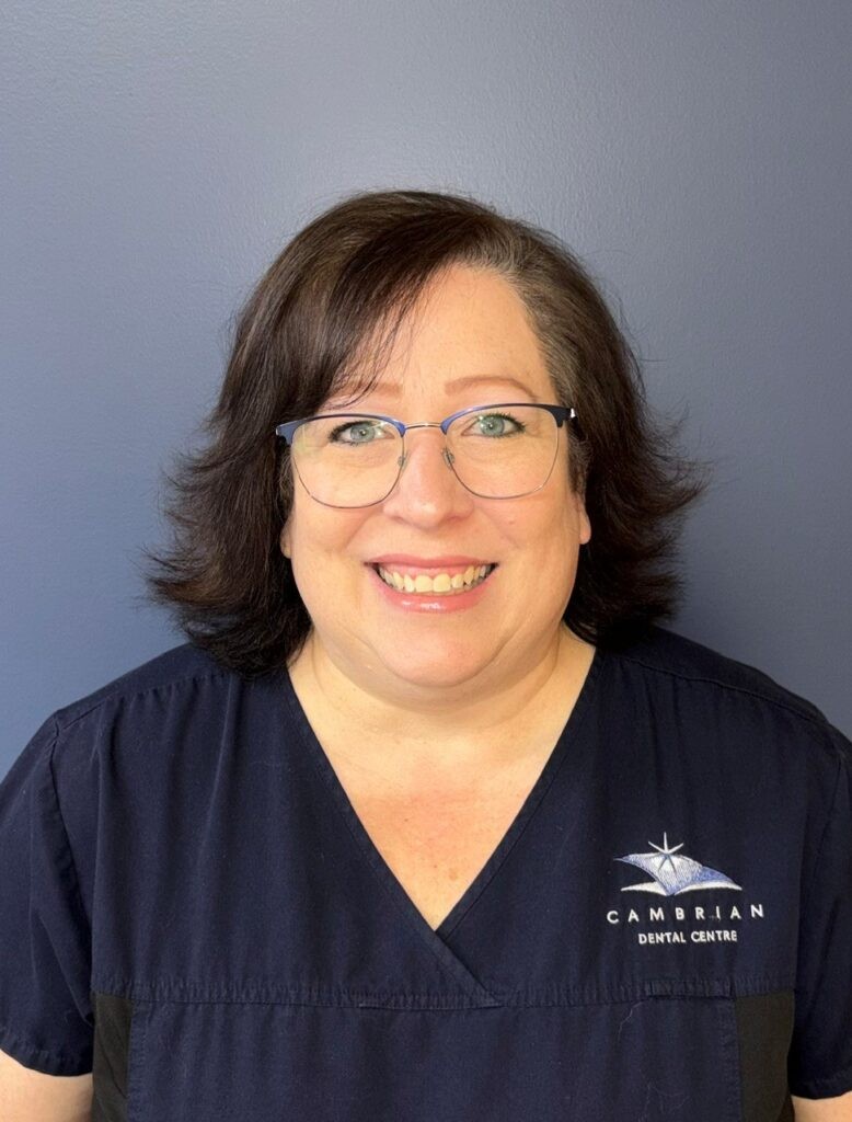 Cambrian Dental Centre team member in dental scrubs with logo