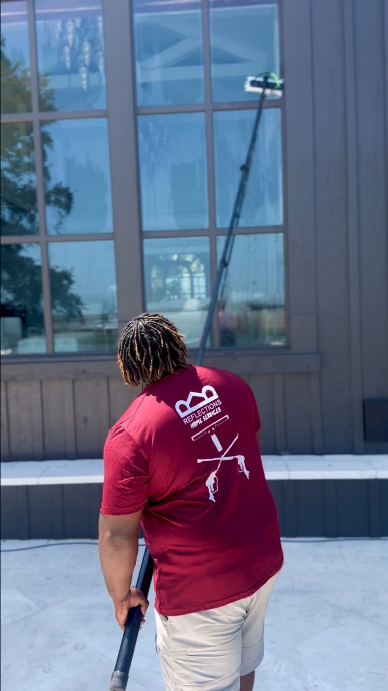 A dark house window with a streak-free reflection, implying cleanliness