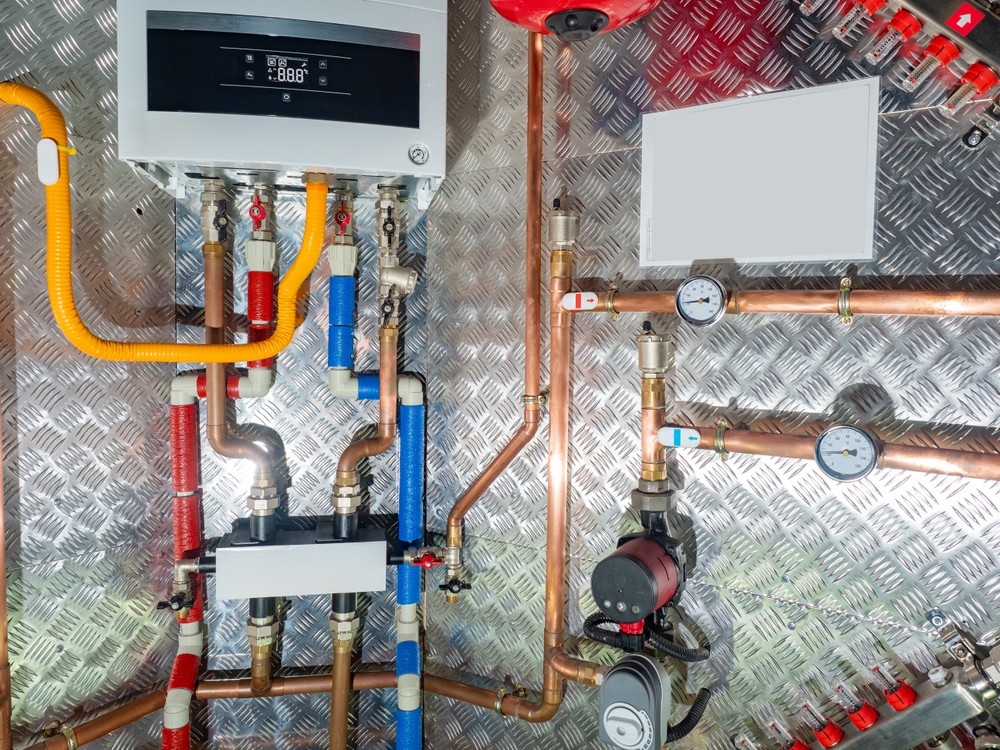 ACS Mechanical Inc. industrial mechanical system with copper piping, gauges, and control panel