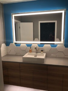 Protractor Roofing bathroom vanity with mirror and wall tile backsplash