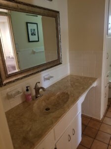 Bathroom vanity with stone countertop and sink