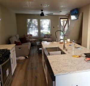 Protractor Roofing interior kitchen renovation with countertop installation in a living room