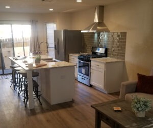 Protractor Roofing kitchen interior with modern stainless steel range hood and appliances