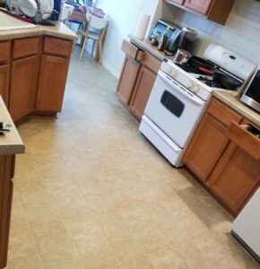 Protractor Roofing team inspecting a kitchen with cabinets and appliances