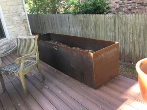 Protractor Roofing copper chimney flashing pan on a wooden deck