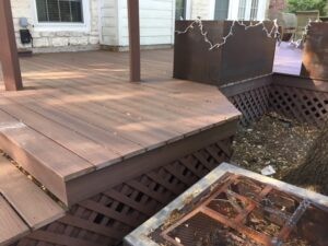 Protractor Roofing team installs wooden decking and a backyard grill area with metal sheet on a residential patio