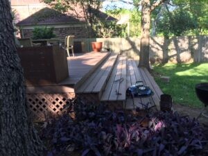 Protractor Roofing backyard roofing materials and walkway installation in a residential yard