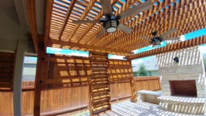 Protractor Roofing interior view of framed covered patio with ceiling fans and installed insulation panels