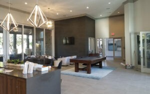 Protractor Roofing office showroom interior with reception counter, pool table, and modern pendant lights