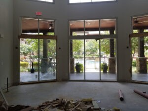 Indoor view with glass doors and large windows, construction materials on the floor