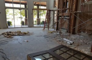 Interior construction site with scaffolding and debris, Protractor Roofing in progress