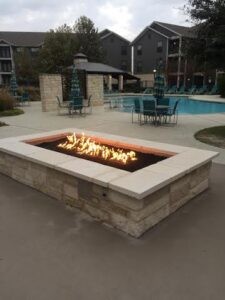 Protractor Roofing outdoor pool area with fire pit and patio seating