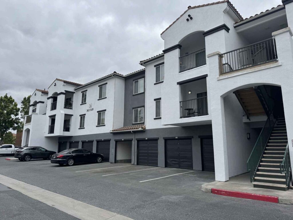 Protractor Roofing commercial building roof installation and exterior with stucco facade and garages