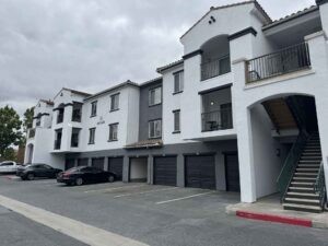 Protractor Roofing commercial building roof installation and exterior with stucco facade and garages