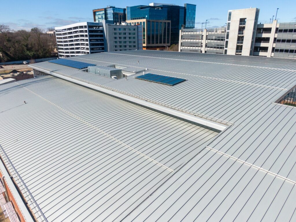 Roofing construction worker measuring and inspecting a roof