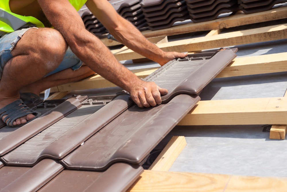 Roofer Laying Tile on Roof - Natural Red Tile