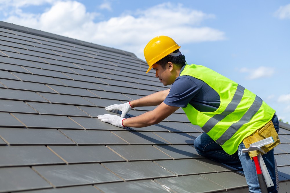 Roofer repairing Slate Roof