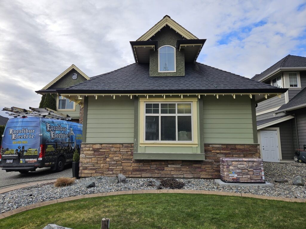 Excalibur Electric Ltd service van parked in front of a residential home exterior