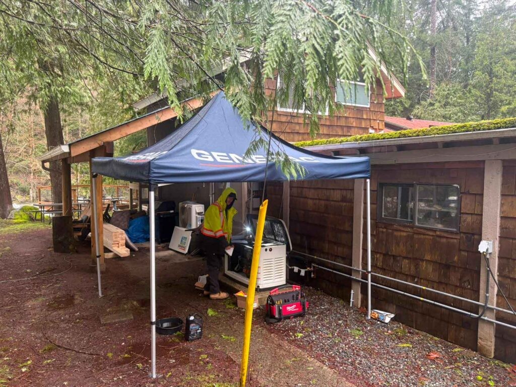 Excalibur Electric Ltd technician working on an outdoor electrical generator setup at a residential site